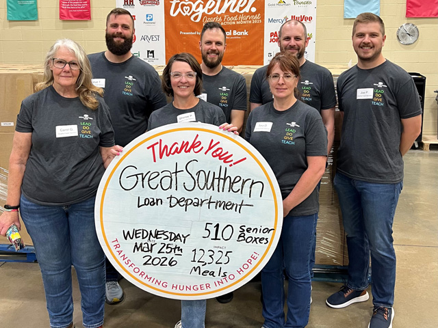 A group of adults holding a sign that explains Great Southern Bank donated 12,325 meals.